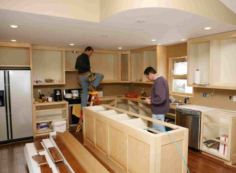 contractors building a kitchen with wood pieces